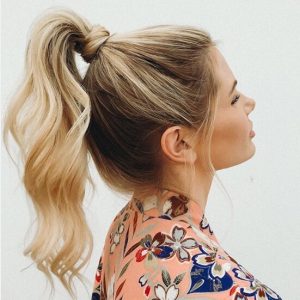 Curly ponytail with loose tendrils