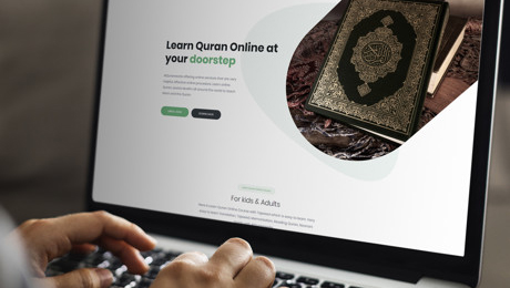 In this image a man searching for Online Quran Academy on his personal laptop.